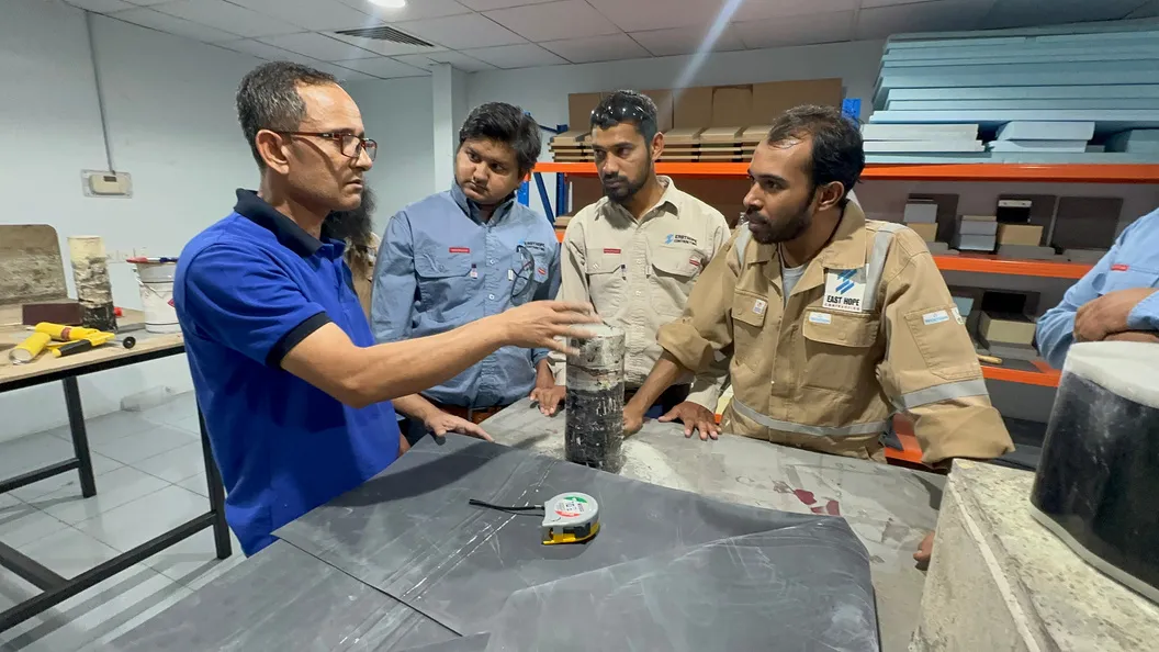 Team examining an asphalt core sample