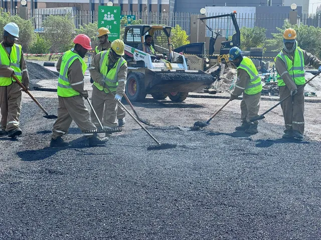 Asphalt finishing crew at urban site