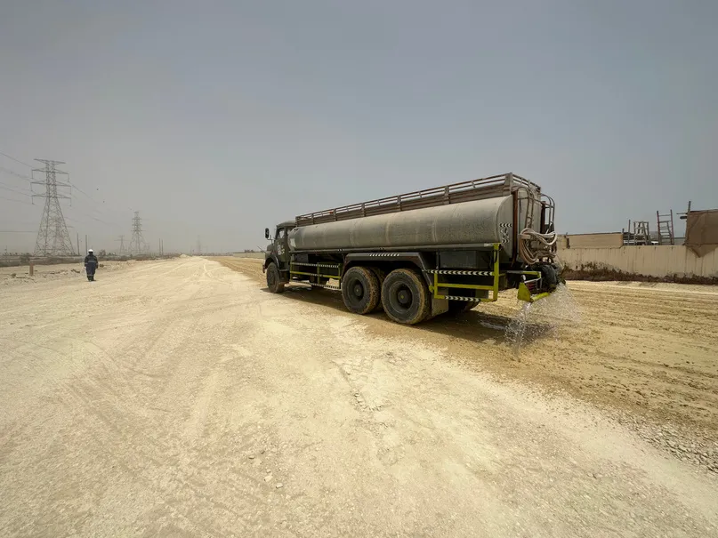 Water tanker spraying a haul road
